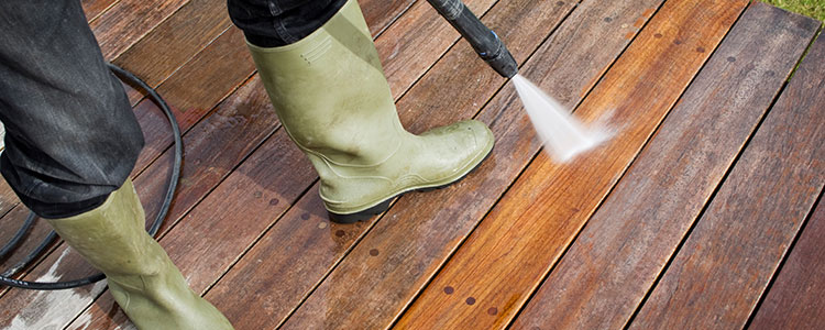 Pressure washing a wood deck with equipment from Pinnacle Rental Centers